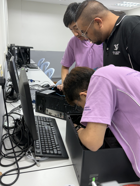 Student learning hardware repair in Professional Diploma in IT Support class at SBIT.