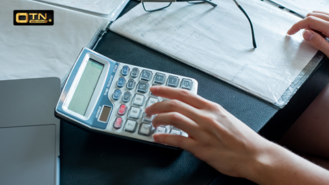 a hand using a calculator