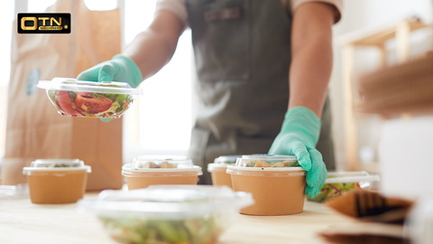 a person holding a container of food