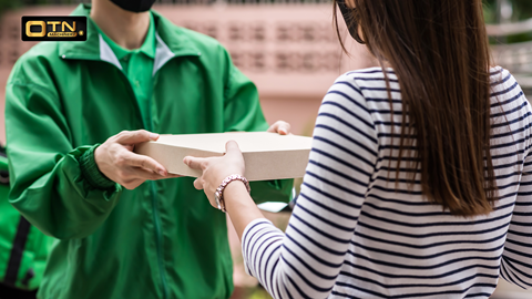 a woman receiving a box from a man