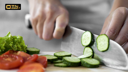 a person cutting vegetables with a knife