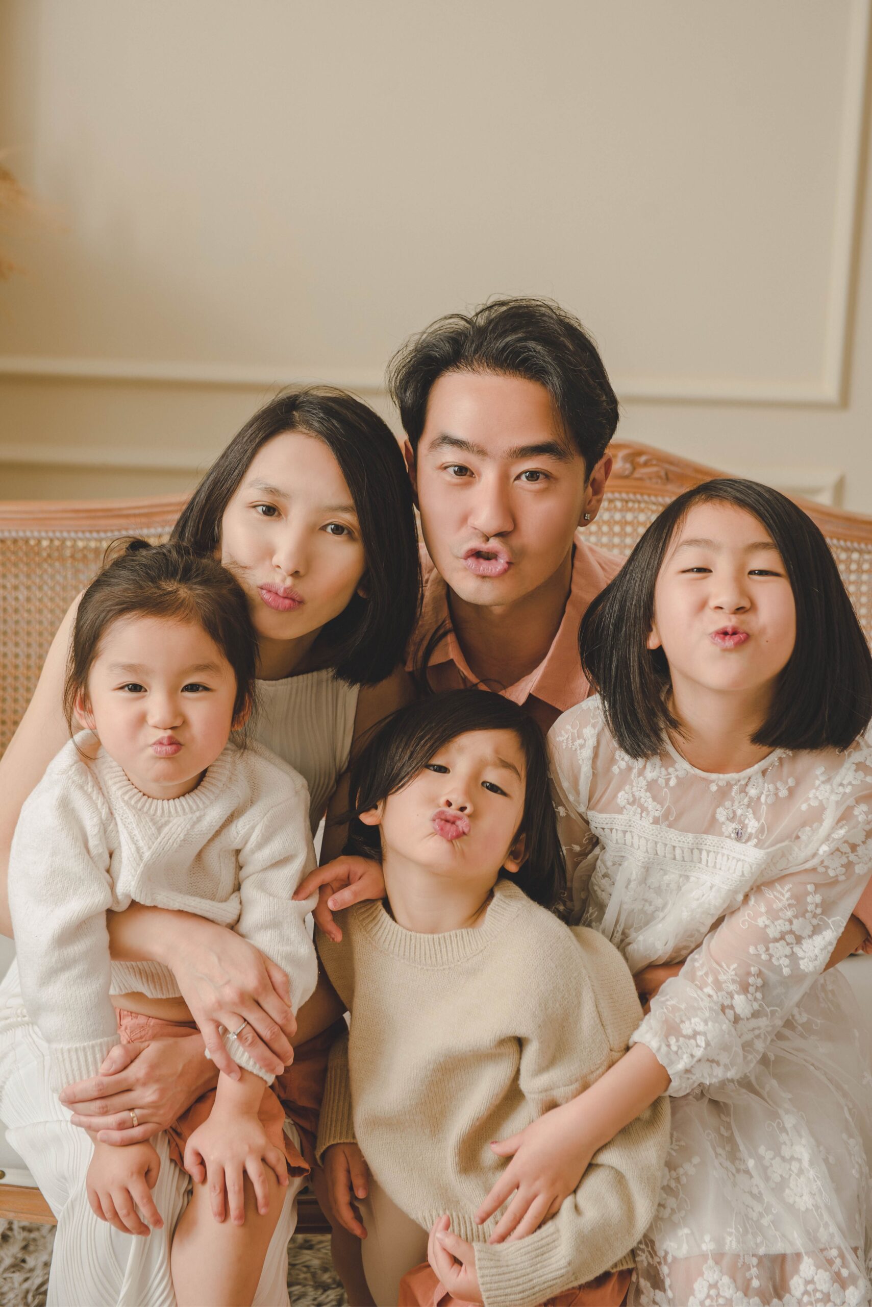 Playful family photography with parents and children showing joyful expressions