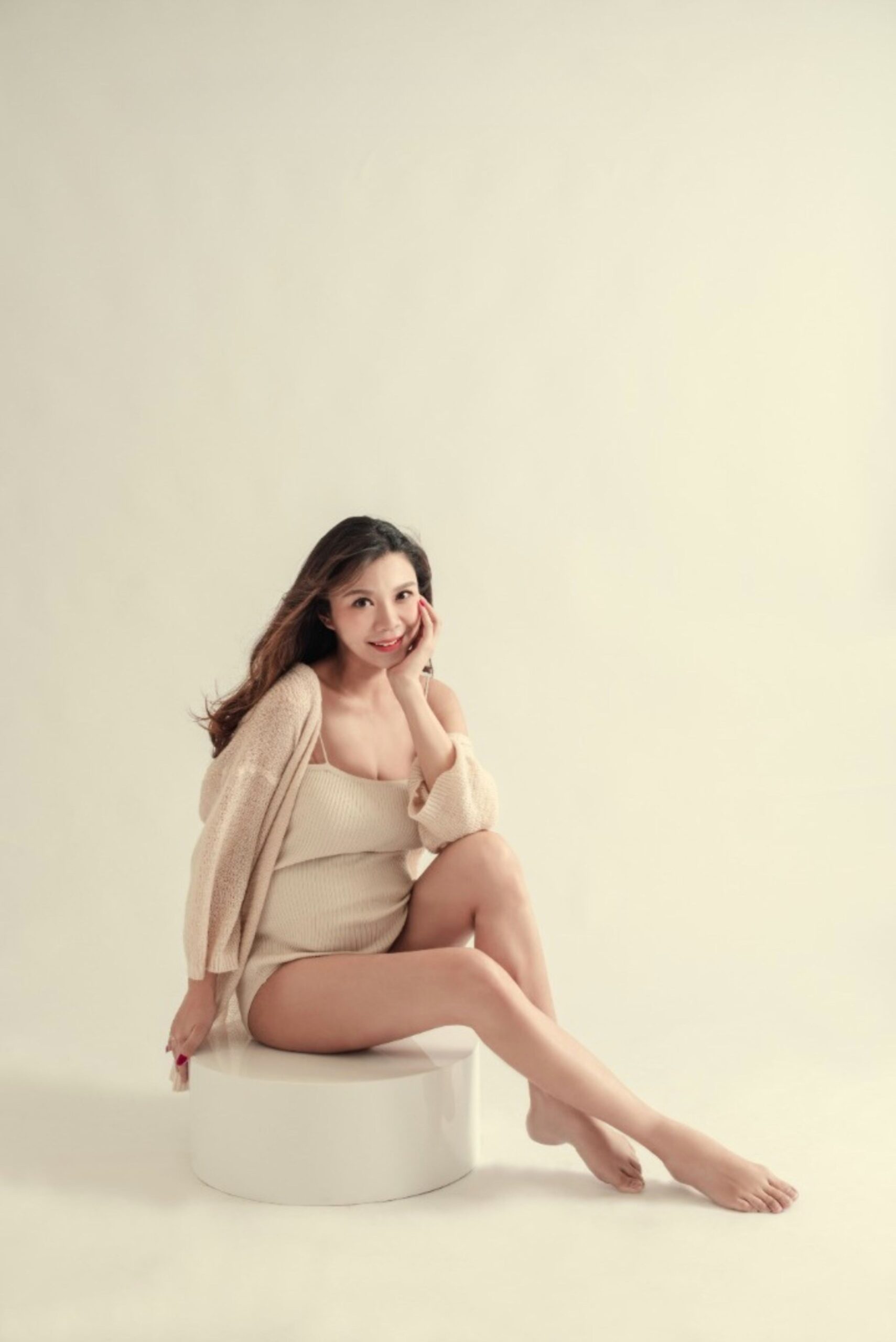 Timeless maternity portrait of expecting mother in elegant studio styling